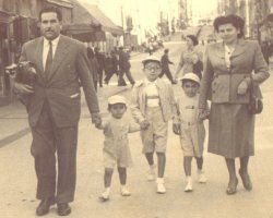 A family of five walking down a street in Vigo