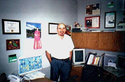 John Xuna standing in his home office