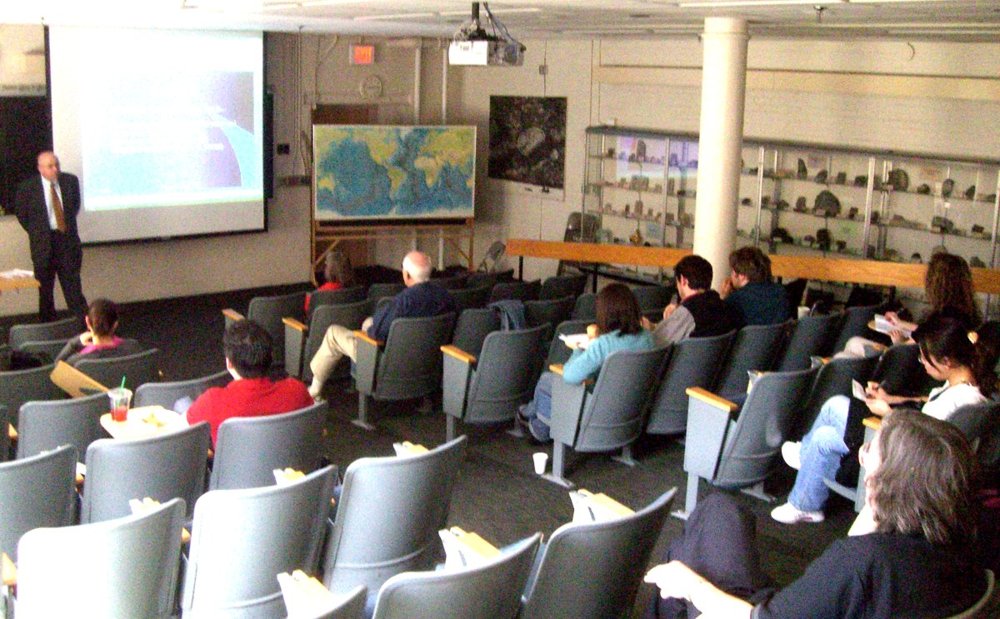 Audience watching a projected presentation in a lecture hall