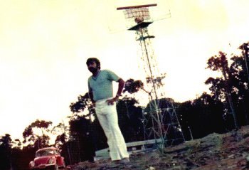 Juan Xuna standing in front of a radar tower in Manaus