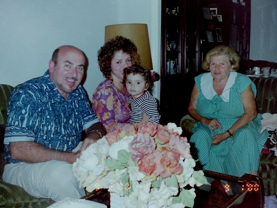Family in a living room with flowers, February 2000